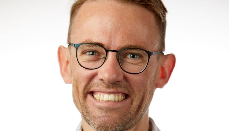 Image of Sam Drummond smiling at the camera
